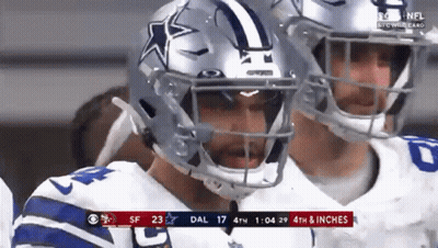 A Football Player Wearing A Helmet With A Star On It Is Standing Next To Another Player . GIF