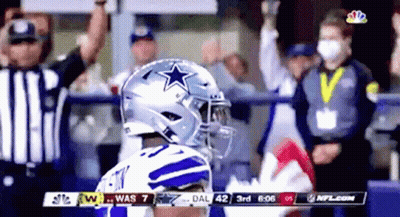 A Football Player Wearing A Helmet With A Star On It Stands In Front Of A Crowd During A Game . GIF