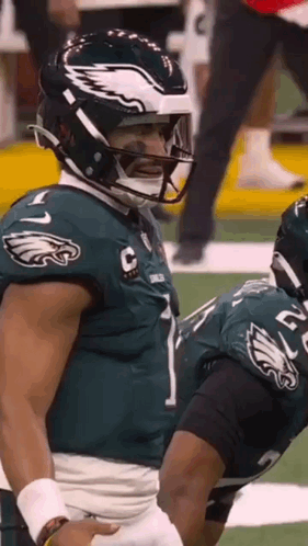 A Football Player Wearing A Helmet With An Eagle On It GIF