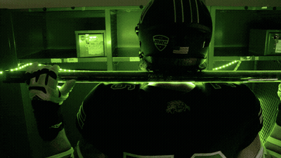 A Football Player Wearing A Helmet With Bleed On It GIF