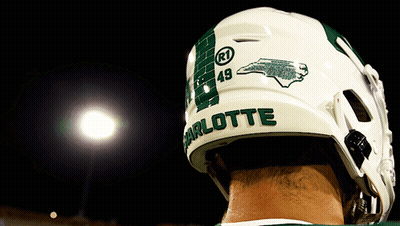 A Football Player Wearing A Helmet With Charlotte On It GIF