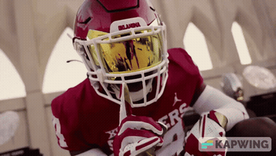 A Football Player Wearing A Helmet With Oklahoma Written On It GIF