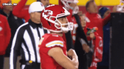 A Football Player Wearing A Helmet With The Letter K On It Stands Next To A Referee GIF