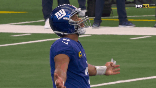A Football Player Wearing A Helmet With The Letter Ny On It GIF
