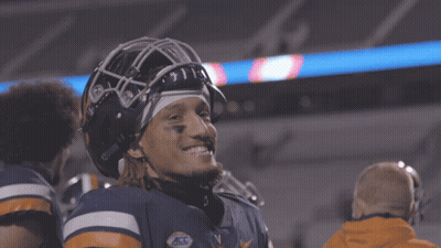 A Football Player Wearing A Helmet With The Letters V On It GIF