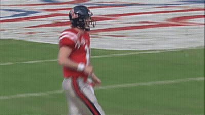 A Football Player Wearing A Helmet With The Number 10 On It GIF