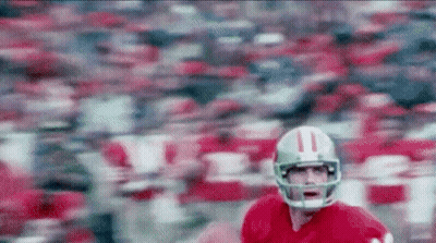 A Football Player Wearing A Helmet With The Number 11 On It Is Running On A Field GIF