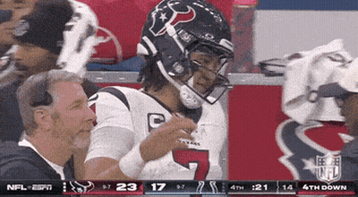 A Football Player Wearing A Helmet With The Number 7 On It Stands In The Stands GIF
