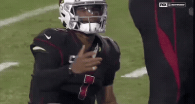 A Football Player Wearing A Helmet With The Number 7 On The Front GIF