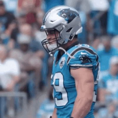 A Football Player Wearing A Helmet With The Number 9 On His Jersey GIF