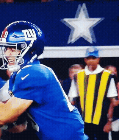 A Football Player Wearing A Helmet With The Ny Giants Logo On It GIF