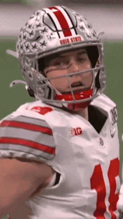 A Football Player Wearing A Helmet With The Word Ohio State On It GIF
