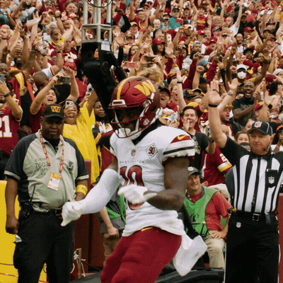 A Football Player Wearing A Jersey That Says Washington GIF