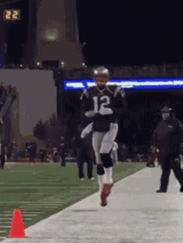 A Football Player Wearing A Jersey With The Number 12 On It GIF