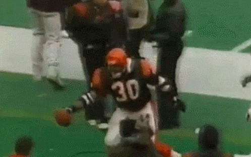 A Football Player Wearing A Jersey With The Number 30 On It Is Running On The Field . GIF