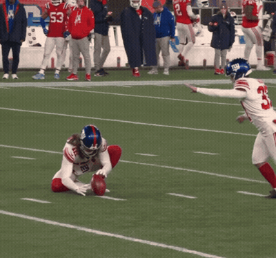 A Football Player Wearing A Jersey With The Number 33 On It GIF