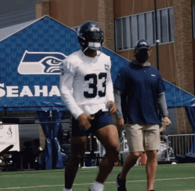 A Football Player Wearing A Jersey With The Number 33 GIF