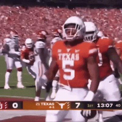 A Football Player Wearing A Jersey With The Number 5 On It Is Running On The Field . GIF