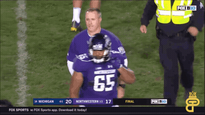 A Football Player Wearing A Jersey With The Number 65 GIF
