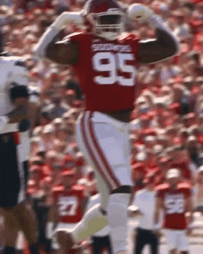 A Football Player Wearing A Jersey With The Number 95 On It GIF