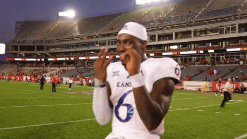 A Football Player Wearing A Kani Jersey Is Standing On The Field GIF
