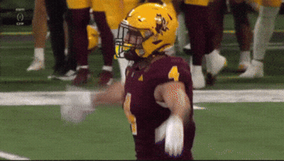 A Football Player Wearing A Maroon Jersey And A Yellow Helmet With The Number 4 On It GIF