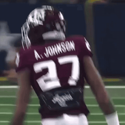 A Football Player Wearing A Maroon Jersey With The Number 27 On It . GIF