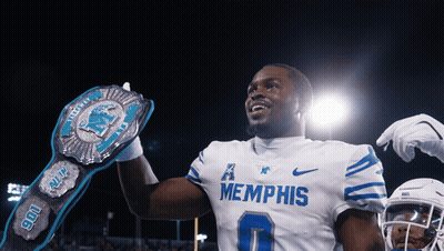 A Football Player Wearing A Memphis Jersey Holds A Championship Belt GIF