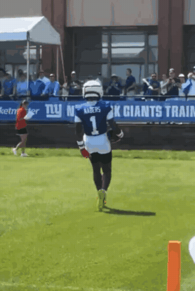 A Football Player Wearing A Number 1 Jersey Is Running On The Field GIF
