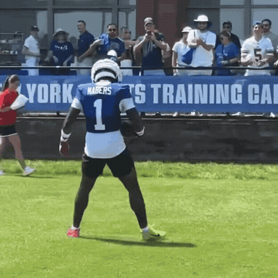 A Football Player Wearing A Number 1 Jersey Stands On The Field GIF