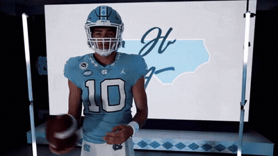 A Football Player Wearing A Number 10 Jersey Holds A Football GIF