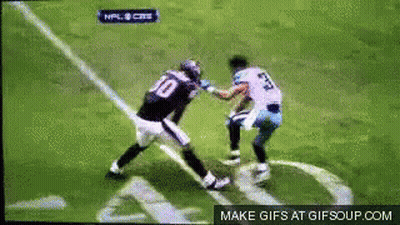 A Football Player Wearing A Number 10 Jersey Is Fighting Another Player GIF