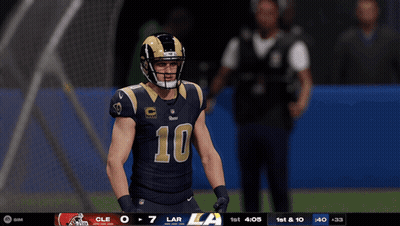 A Football Player Wearing A Number 10 Jersey Stands On A Field GIF