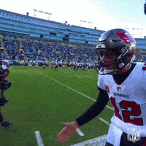 A Football Player Wearing A Number 12 Jersey GIF