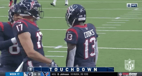 A Football Player Wearing A Number 13 Jersey Talks To Another Player On The Field GIF