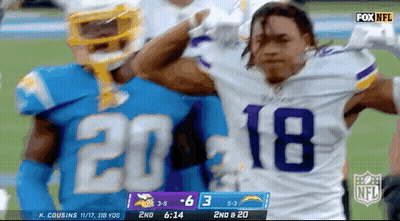 A Football Player Wearing A Number 18 Jersey Stands Next To Another Player GIF