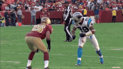 A Football Player Wearing A Number 19 Jersey Stands In Front Of Another Player Wearing A Number 26 Jersey GIF