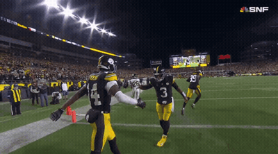 A Football Player Wearing A Number 3 Jersey Holds Hands With Another Player GIF