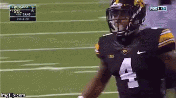 A Football Player Wearing A Number 4 Jersey Is Running On The Field GIF