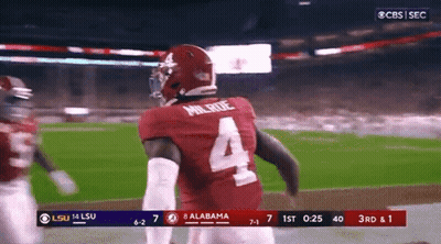 A Football Player Wearing A Number 4 Jersey Is Running On The Field GIF