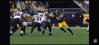 A Football Player Wearing A Number 40 Jersey Is Being Tackled By Another Player GIF