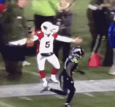 A Football Player Wearing A Number 5 Jersey Is Running On A Field . GIF