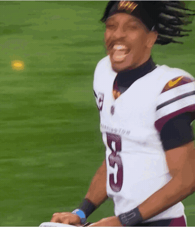 A Football Player Wearing A Number 5 Jersey Is Smiling GIF