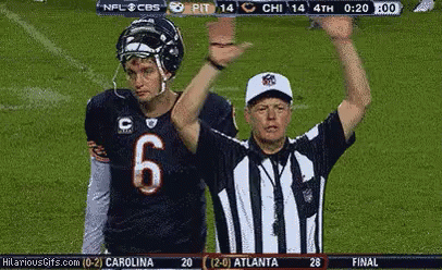 A Football Player Wearing A Number 6 Jersey Stands Next To A Referee . GIF