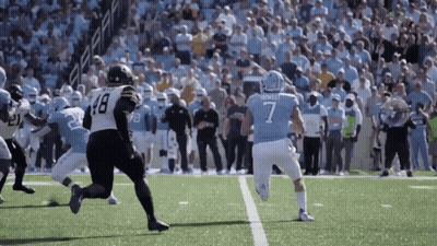 A Football Player Wearing A Number 7 Jersey Is Running On The Field GIF