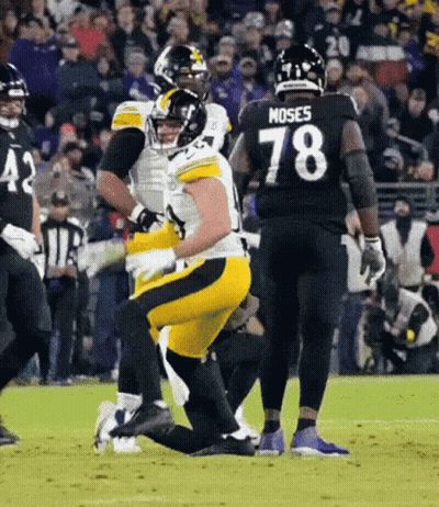 A Football Player Wearing A Number 78 Jersey Is Kneeling On The Field . GIF