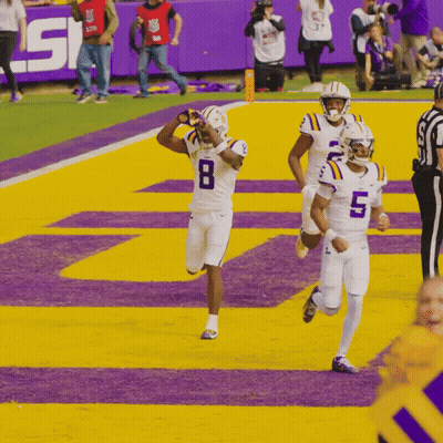 A Football Player Wearing A Number 8 Jersey Is Running On The Field GIF