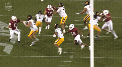A Football Player Wearing A Number 8 Jersey Is Surrounded By Other Players GIF