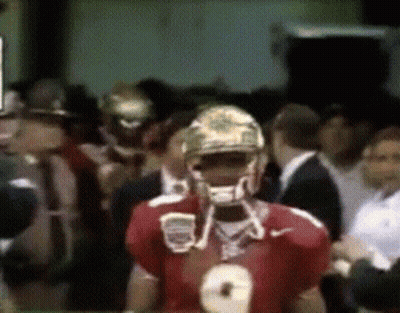 A Football Player Wearing A Number 8 Jersey Stands In A Crowd GIF