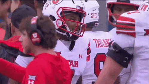 A Football Player Wearing A Number 8 Jersey Talks To A Coach GIF